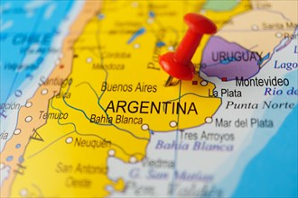 Argentina marked with a red thumbtack on a map with an out-of-focus background