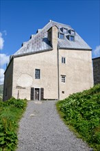 Side view with entrance to chapel in historic hotel accommodation Ospizio San Gottardo Sankt Gotthard Hospice with historic buildings from year 1237 13th century on 2091 metres high Gotthard Pass