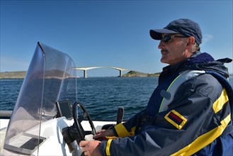 Man driving motorboat on the Atlantic Strait in Norway