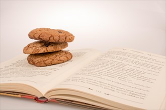 Chocolate chip cookies placed on a book
