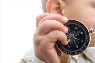 Isolated compass in baby's hand on a white background
