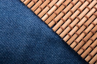 Straw mat placed on denim canvas as a background