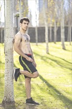 Attractive young man posing in the park after exercising