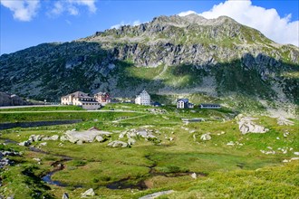 Panoramic view onto the high plateau at the top of the pass 2091 metres high Gotthard Pass with historic buildings in the middle historic hotel accommodation Ospizio San Gottardo Saint Gotthard Hospic...