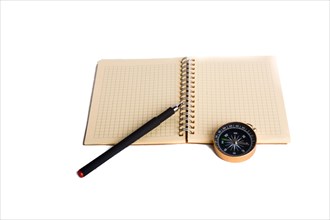 Spiral notebook and pollpoint pen and compass on a white background