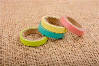 Colorful insulating adhesive tape on linen canvas background