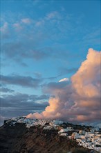 Whitewashed houses on the caldera at sunset