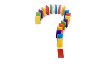 Question mark with colored wooden dominos on a white background