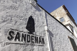 Logo of the port winery Sandeman on a white wall