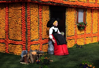 Half-timbered house and woman in traditional traditional costume