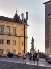 Statue with pedestrians in the evening light