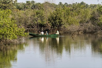 Tourists with canoe on the Kotu River watching and photographing birds