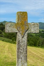 Heart carved on a stone cross. Auvergne Volcanoes Natural Park. Puy de Dome. Auvergne Rhone Alpes. France