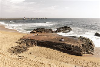 Sandy beach beach with granite rocks at the Douro estuary