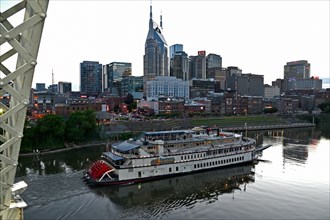 View from the John Seigenthaler Pedestrian Bridge over the Cumberland River to the Nashville skyline with paddle steamer