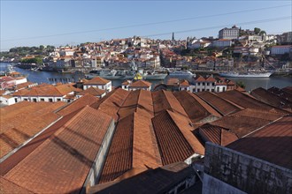 View over the roofs of port wine cellars in Vila Nova de Gaia to the historic old town of Porto