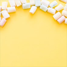 Soft marshmallows edge yellow background
