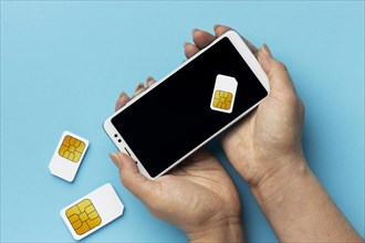 Front view hands holding smartphone sim cards