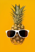 Top view exotic pineapple with sunglasses