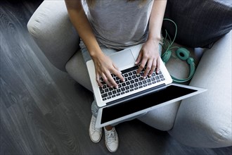 Young woman typing laptop