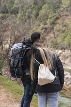 Couple with backpack exploring nature 3