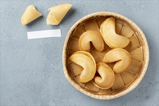 Flat lay fortune cookies bowl with blank note