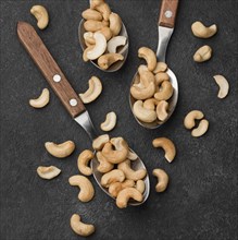 Close up spoons filled with healthy raw cashew nuts