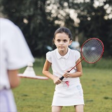Portrait cute girl playing badminton
