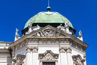 Copper roof with stone figures on the upper baroque Belvedere Palace