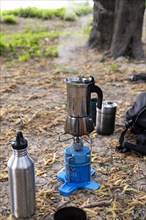 An espresso maker on a camping gas barbecue