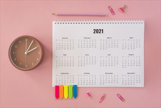Flat lay desk calendar pink background