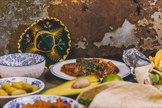 Different delicious mexican dishes rusty background with mexican hat