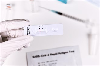Hand holding Corona Virus Rapid Antigen Test with negative result