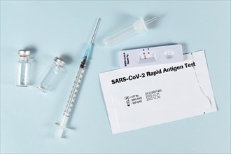 Tools to fight Corona Virus pandemic including rapid antigen test and vaccine vials with syringe