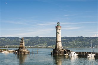 Harbour entrance of Lindau at Lake Constance with lighthouse and mountains