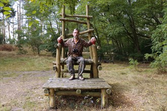 Throne made of beams in the forest along the Elbe cycle path