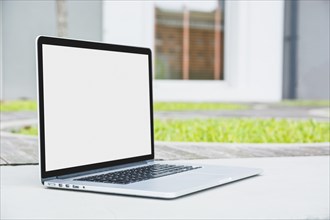 Laptop with blank white screen walkway