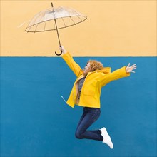Girl jumping umbrella