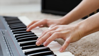 Close up female musician playing piano keyboard
