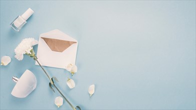 Envelope with white flower perfume table