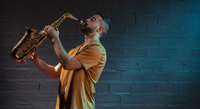 Male musician playing saxophone spotlight with copy space