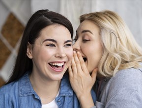 Women telling secret laughing