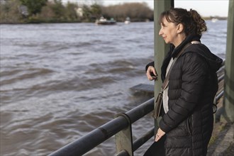 Thoughtful mature woman contemplating the river