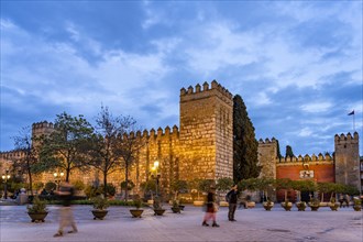 Tower and walls of the Alcazar Royal Palace at dusk