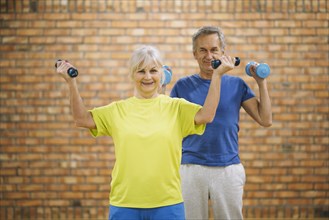 Elderly couple working out gym