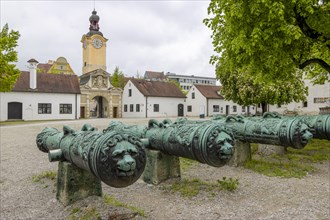 Old cannons and in the background Baroque clock tower at the entrance of the Bavarian Army Museum
