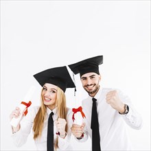 Cheerful young graduating couple