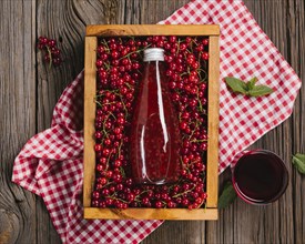 Cranberry juice bottle wooden background