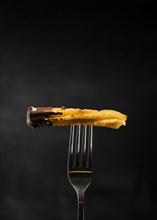 Minimalist fried churros fork front view