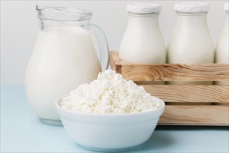 Close up milk jug with fresh cottage cheese